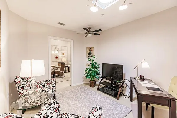 a living room with furniture potted plant and a window