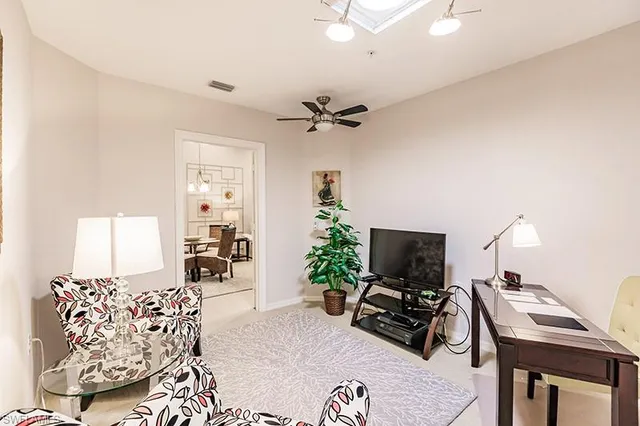 a living room with furniture potted plant and a window