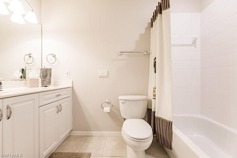 8135 Celeste Drive, Unit 4218 Naples, FL 34113 - Photo 28 of 37 a bathroom with a sink a toilet and shower