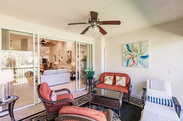 a living room with furniture a rug and a window