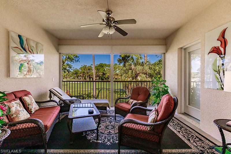 8135 Celeste Drive, Unit 4218 Naples, FL 34113 - Photo 33 of 37 a living room with furniture a rug and a window