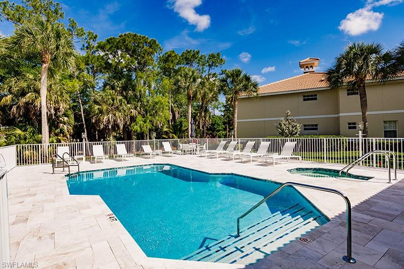 8135 Celeste Drive, Unit 4218 Naples, FL 34113 - Photo 36 of 37 a swimming pool with outdoor seating and yard