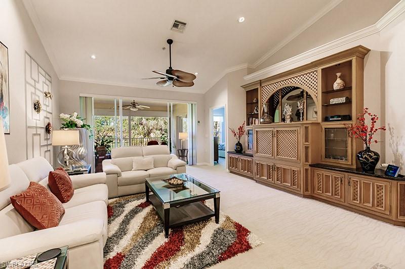 8135 Celeste Drive, Unit 4218 Naples, FL 34113 - Photo 5 of 37 a living room with furniture and a flat screen tv
