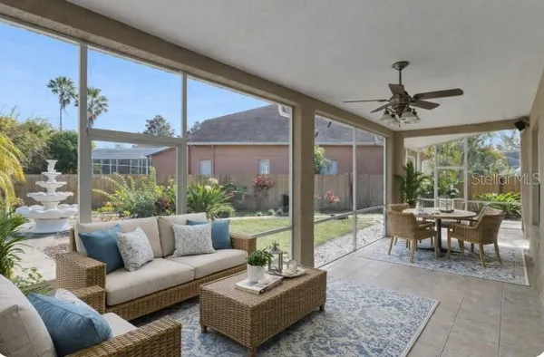 a view of a porch with furniture and garden