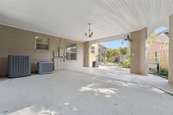 a aerial view of a house with table and chairs under an umbrella
