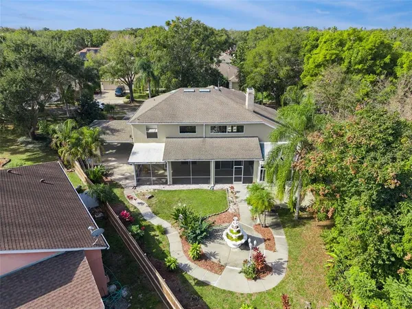 a view of a house with backyard and sitting area