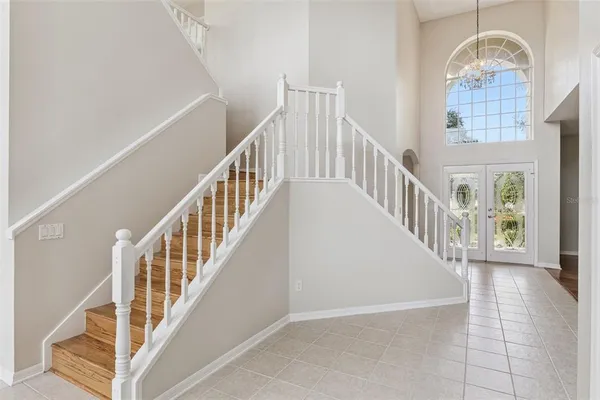 a view of staircase with white walls and windows