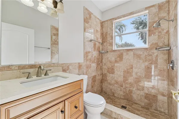 a view of a livingroom with a ceiling fan and window