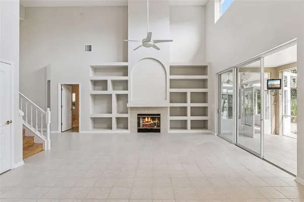a view of a livingroom with a fireplace and workspace