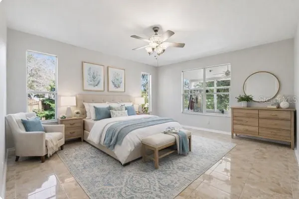 a spacious bedroom with a bed a couch and window