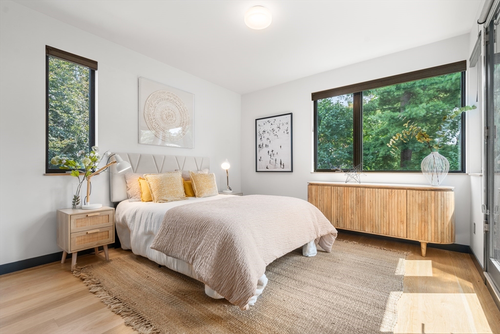20 Madison Street Cambridge, MA 02138 - Photo 15 of 37 a bedroom with a bed lamp and a large window