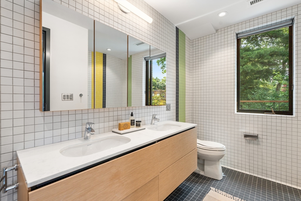 20 Madison Street Cambridge, MA 02138 - Photo 17 of 37 a bathroom with a toilet sink and mirror