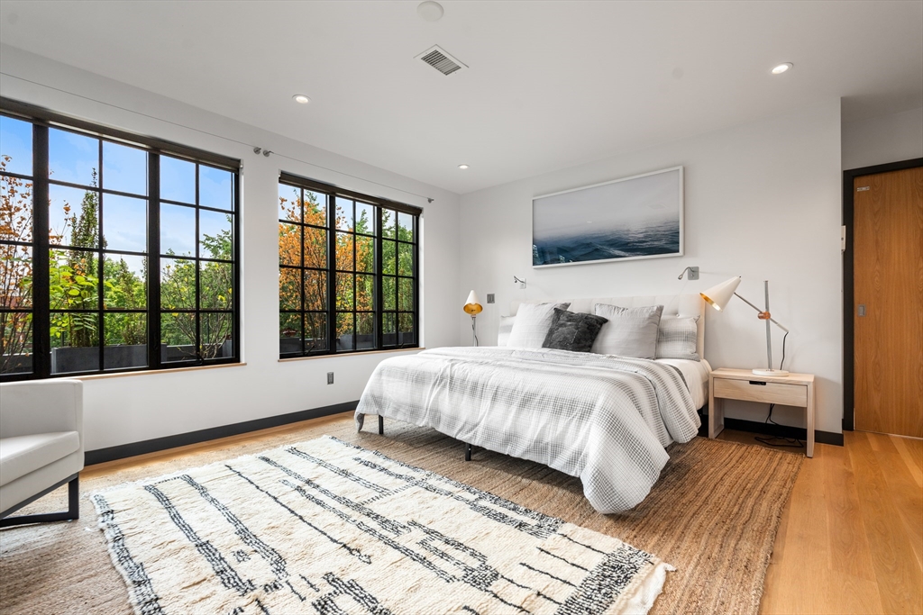 20 Madison Street Cambridge, MA 02138 - Photo 19 of 37 a bedroom with a large bed and a large window