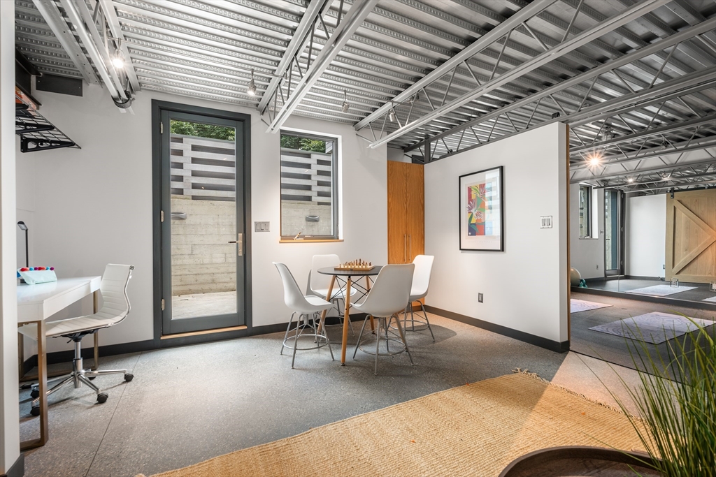 20 Madison Street Cambridge, MA 02138 - Photo 27 of 37 a living room with furniture a bed and a chandelier