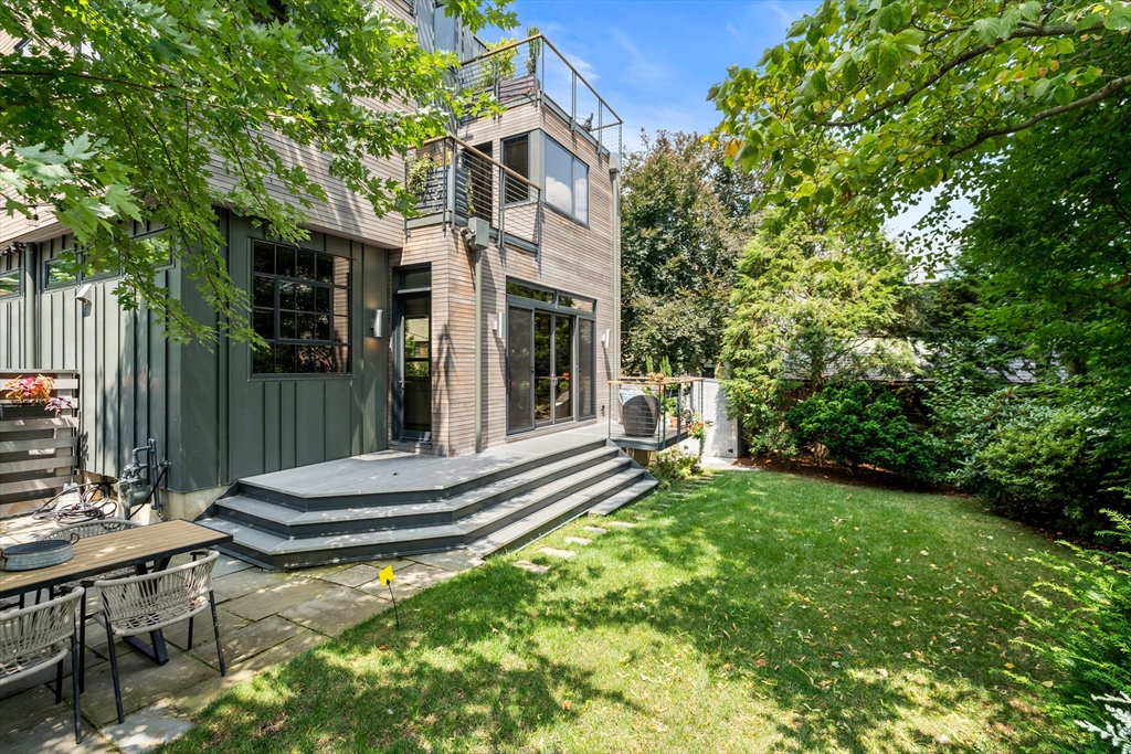 20 Madison Street Cambridge, MA 02138 - Photo 32 of 37 a view of a chair and tables in the backyard of the house