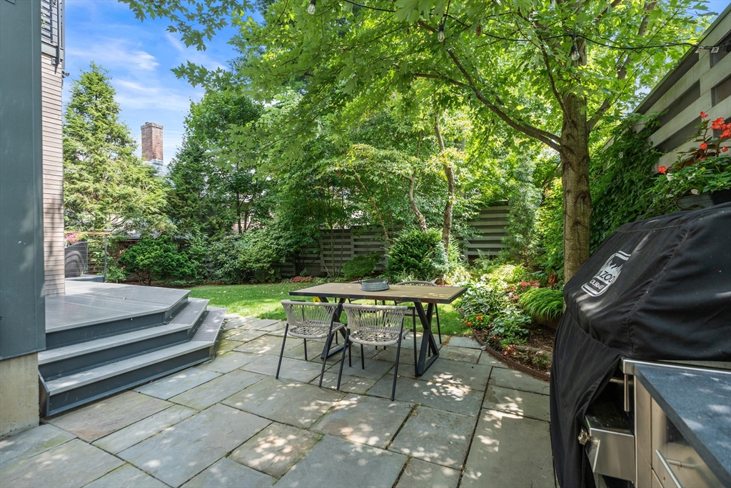 20 Madison Street Cambridge, MA 02138 - Photo 33 of 37 a patio with table and chairs and potted plants
