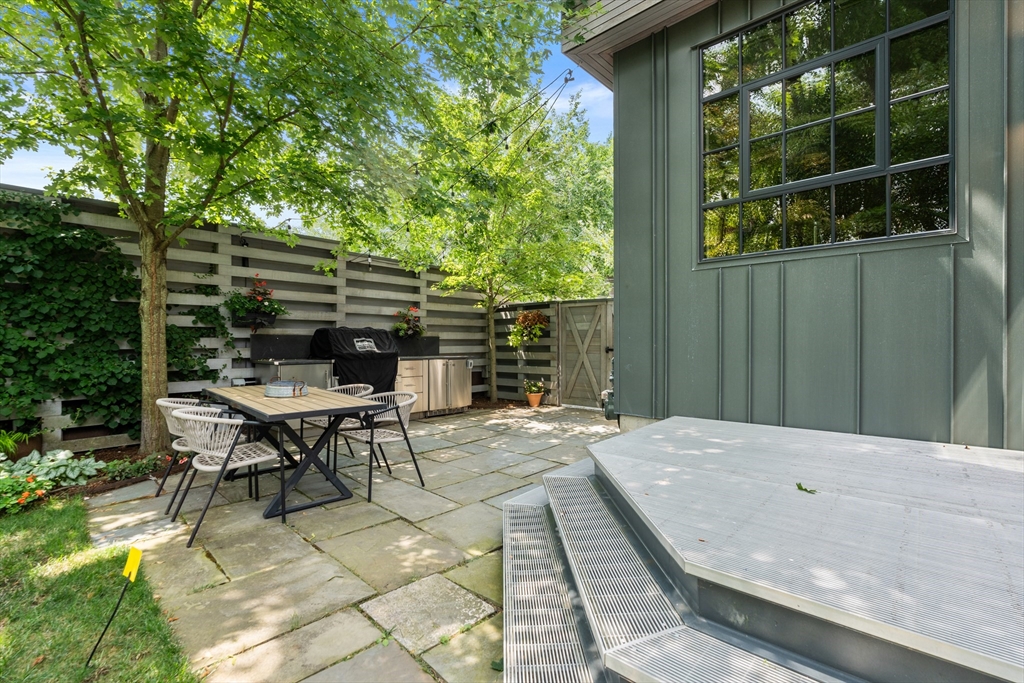 20 Madison Street Cambridge, MA 02138 - Photo 34 of 37 a backyard of a house with table and chairs
