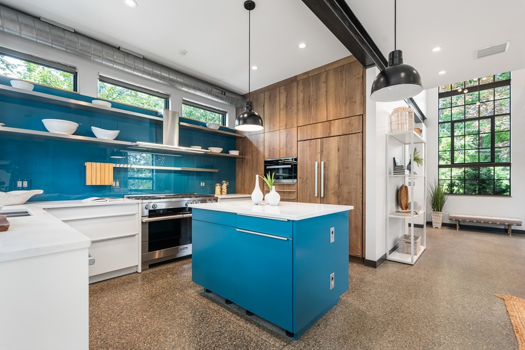 20 Madison Street Cambridge, MA 02138 - Photo 9 of 37 a kitchen with stainless steel appliances granite countertop a stove and a refrigerator