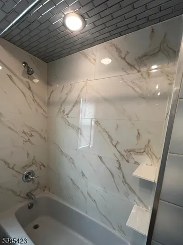 a bathroom with a shower and vanity
