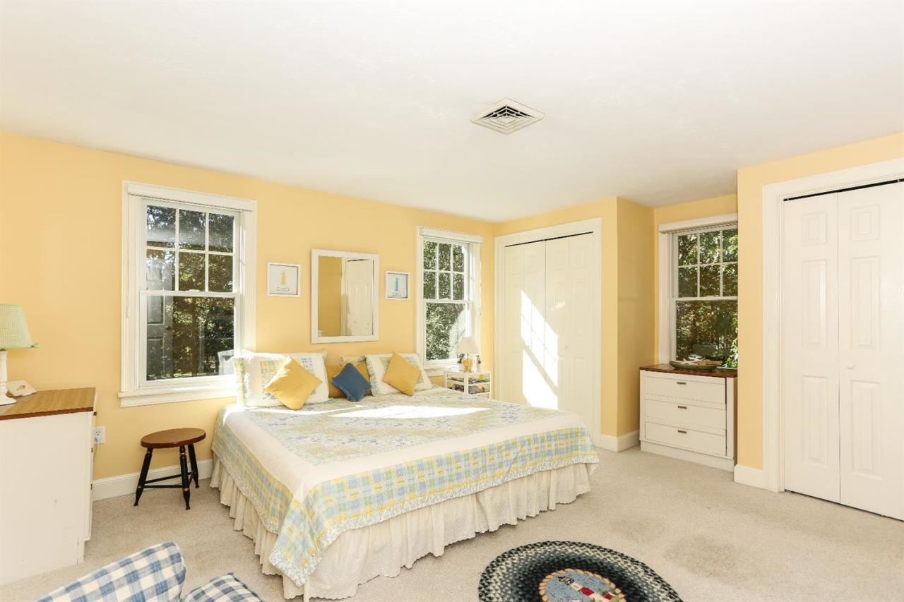 218 Little River Road Cotuit, MA 02635 - Photo 24 of 30 a bedroom with a bed and wooden floor
