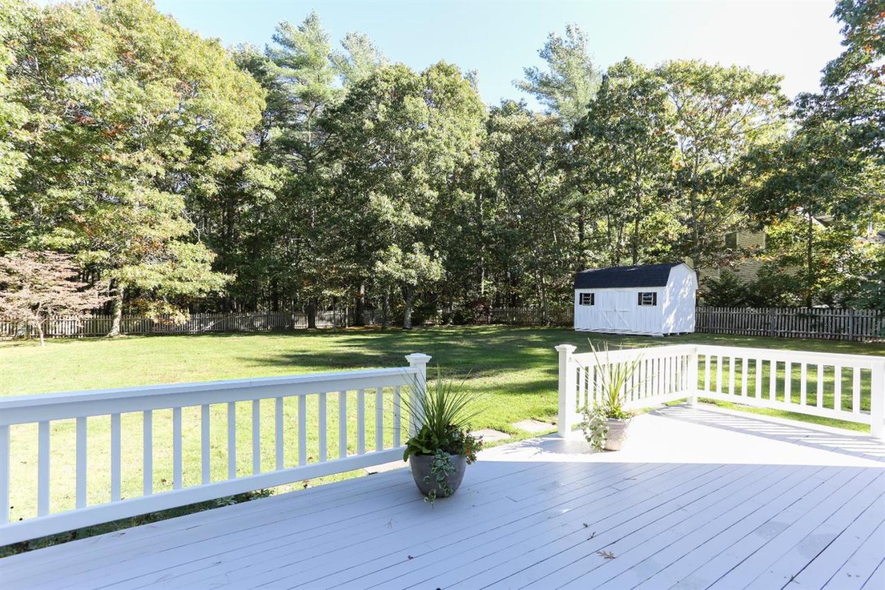218 Little River Road Cotuit, MA 02635 - Photo 27 of 30 a view of a street with a bench and trees
