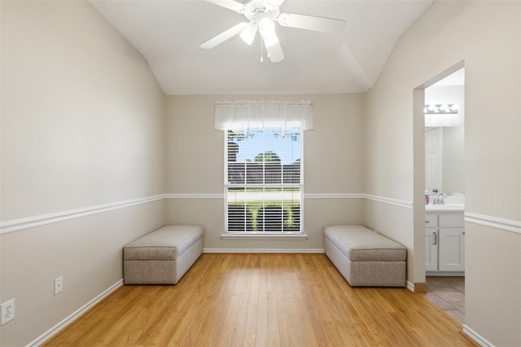 4218 Glistening Spring Rowlett, TX 75088 - Photo 28 of 39 Vaulted ceiling room featuring wood-finish flooring, a window with blinds, and decorative chair rail molding