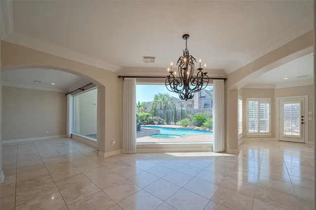 a view of a big room with wooden floor chandelier and chandelier