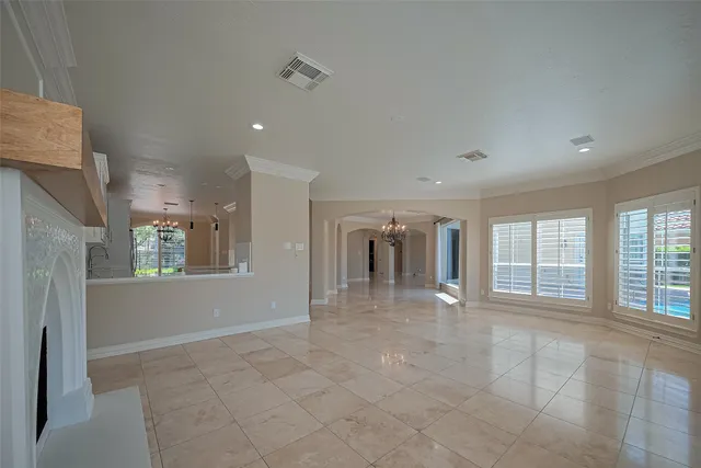a view of an empty room with a fireplace and a window