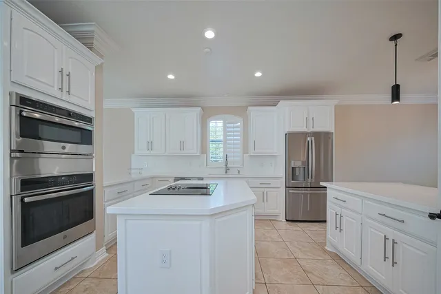 a kitchen with cabinets and stainless steel appliances