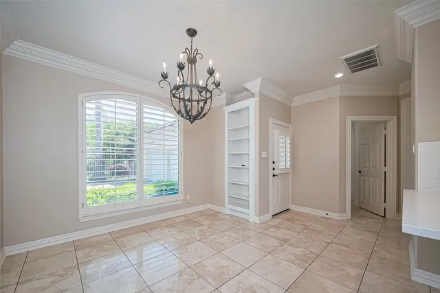 a view of a big room with windows and chandelier