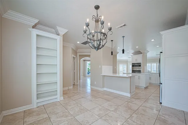 a view of a kitchen with refrigerator and cabinets