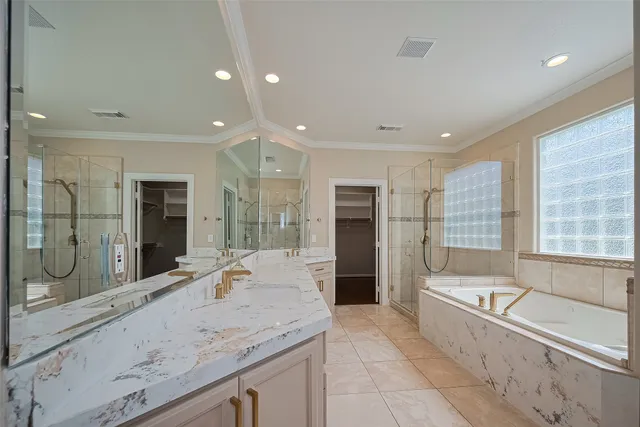 a bathroom with a granite countertop tub sink shower and mirror