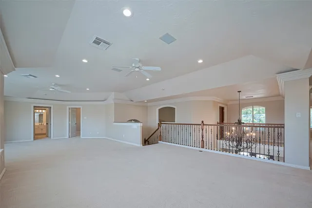 a view of a big room with wooden cabinet and windows
