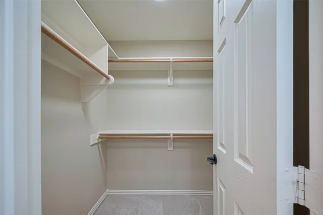 a spacious bathroom with a double vanity sink a mirror and shower