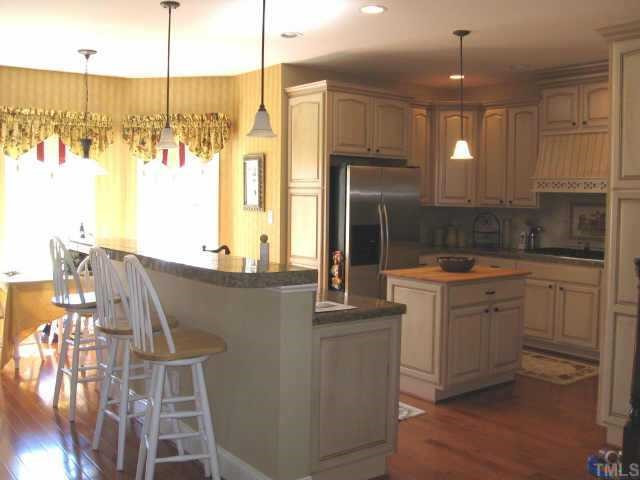 3320 La Costa Way Raleigh, NC 27610 - Photo 3 of 10 A chef's dream kitchen! Fully equipped with Kitchenaid stainless steel appliances...gas cooktop, double ovens, warming drawer & side by side refrigerator. Center island with butcher block! Other