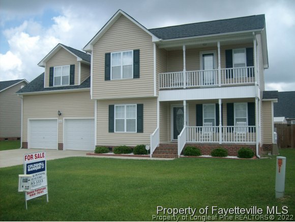 1412 Rough Rider Lane Parkton, NC 28371 - Photo 1 of 12 a front view of a house with a yard