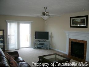 1412 Rough Rider Lane Parkton, NC 28371 - Photo 4 of 12 a living room with furniture a flat screen tv and a fireplace