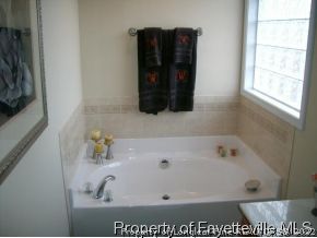1412 Rough Rider Lane Parkton, NC 28371 - Photo 8 of 12 a bathroom with a bathtub