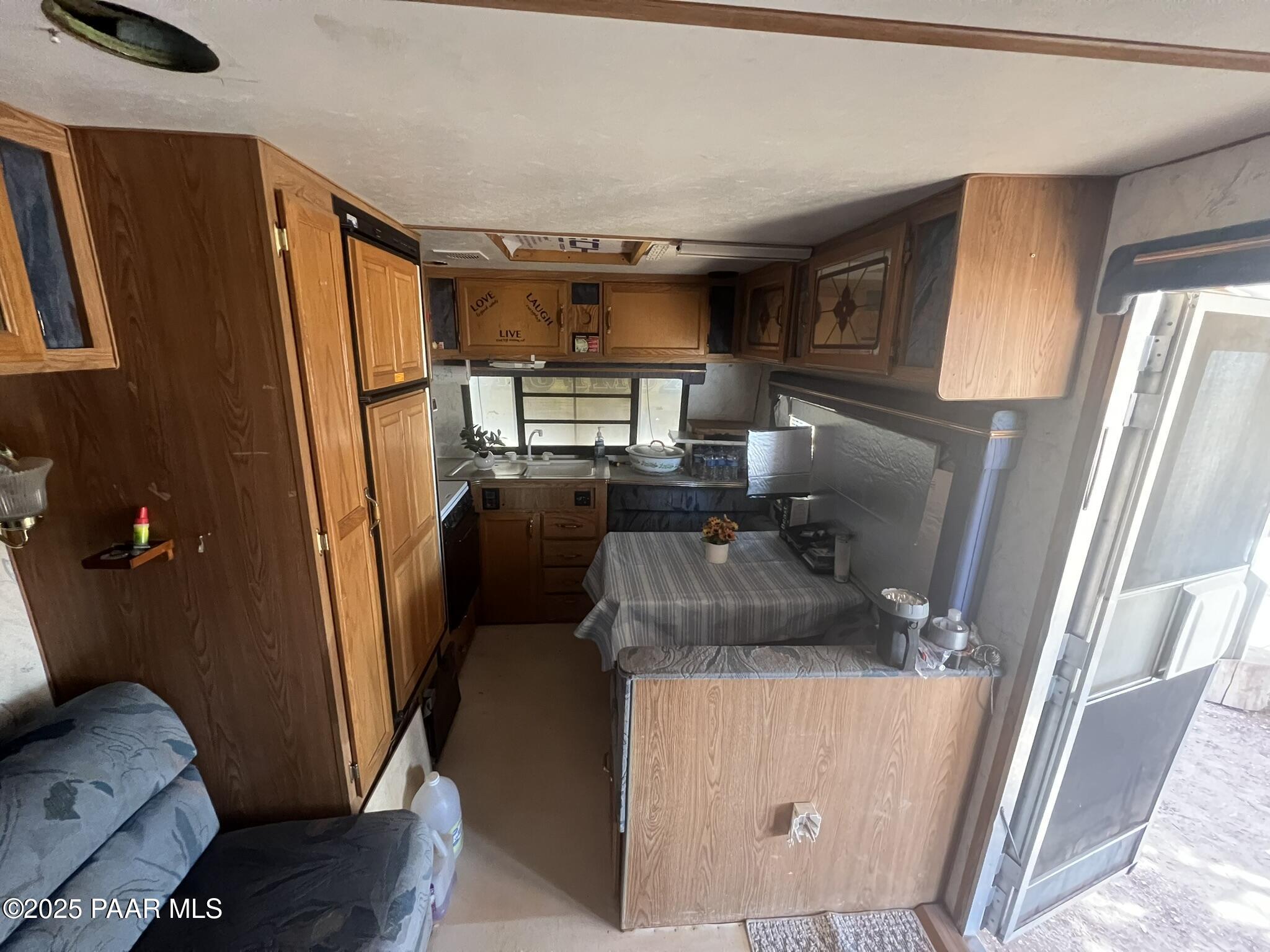 228 Flying Wrench Road Ash Fork, AZ 86320 - Photo 14 of 16 a living room with furniture and a flat screen tv