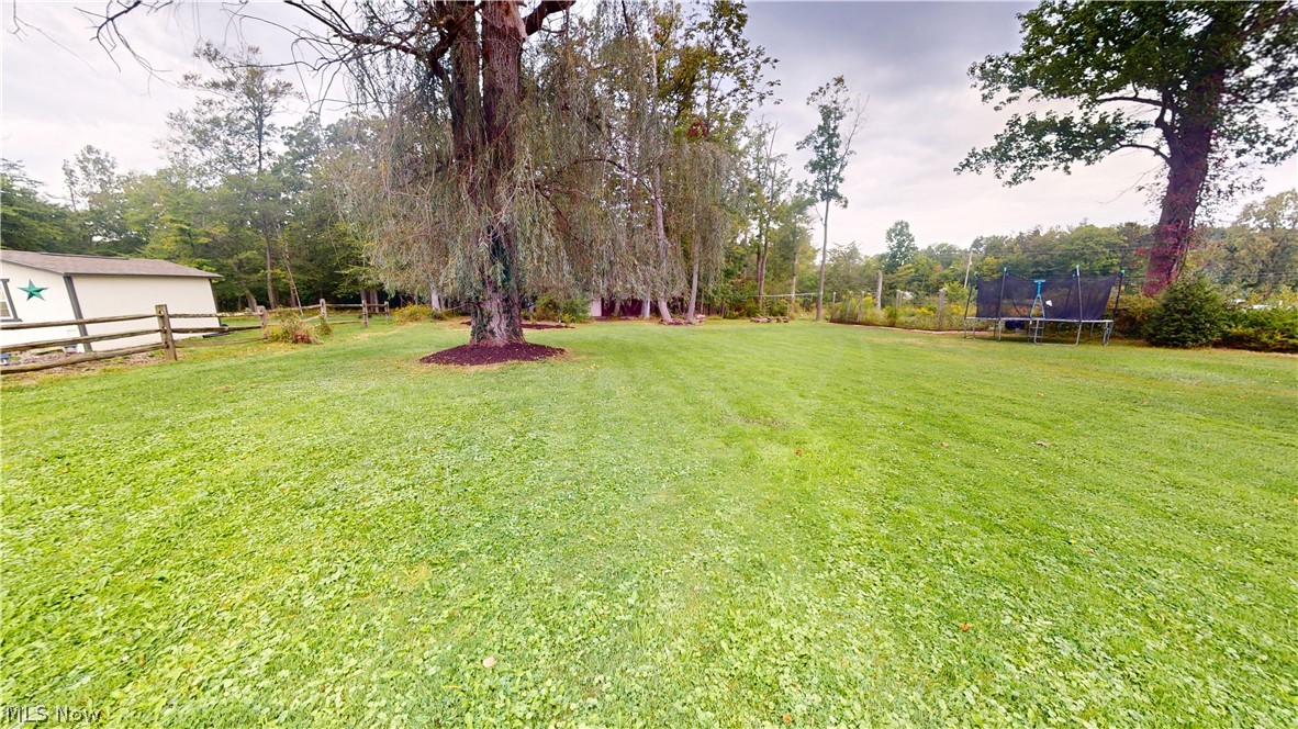 9260 Avery Road Broadview Heights, OH 44147 - Photo 37 of 43 Expansive grassy yard with mature trees and a white-sided structure