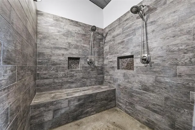 a view of a hallway with wooden floor and windows