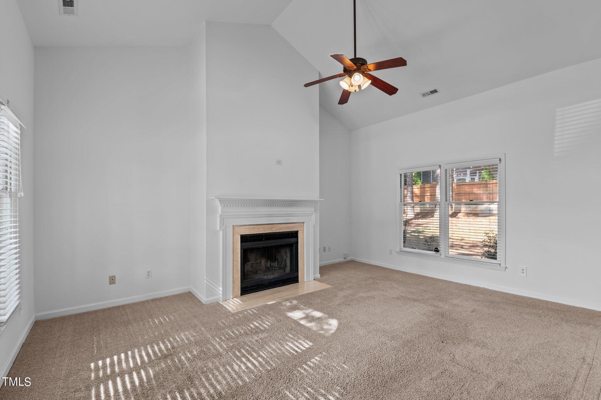 12116 Ranleigh Court Raleigh, NC 27613 - Photo 10 of 30 a view of empty room with fireplace and fan