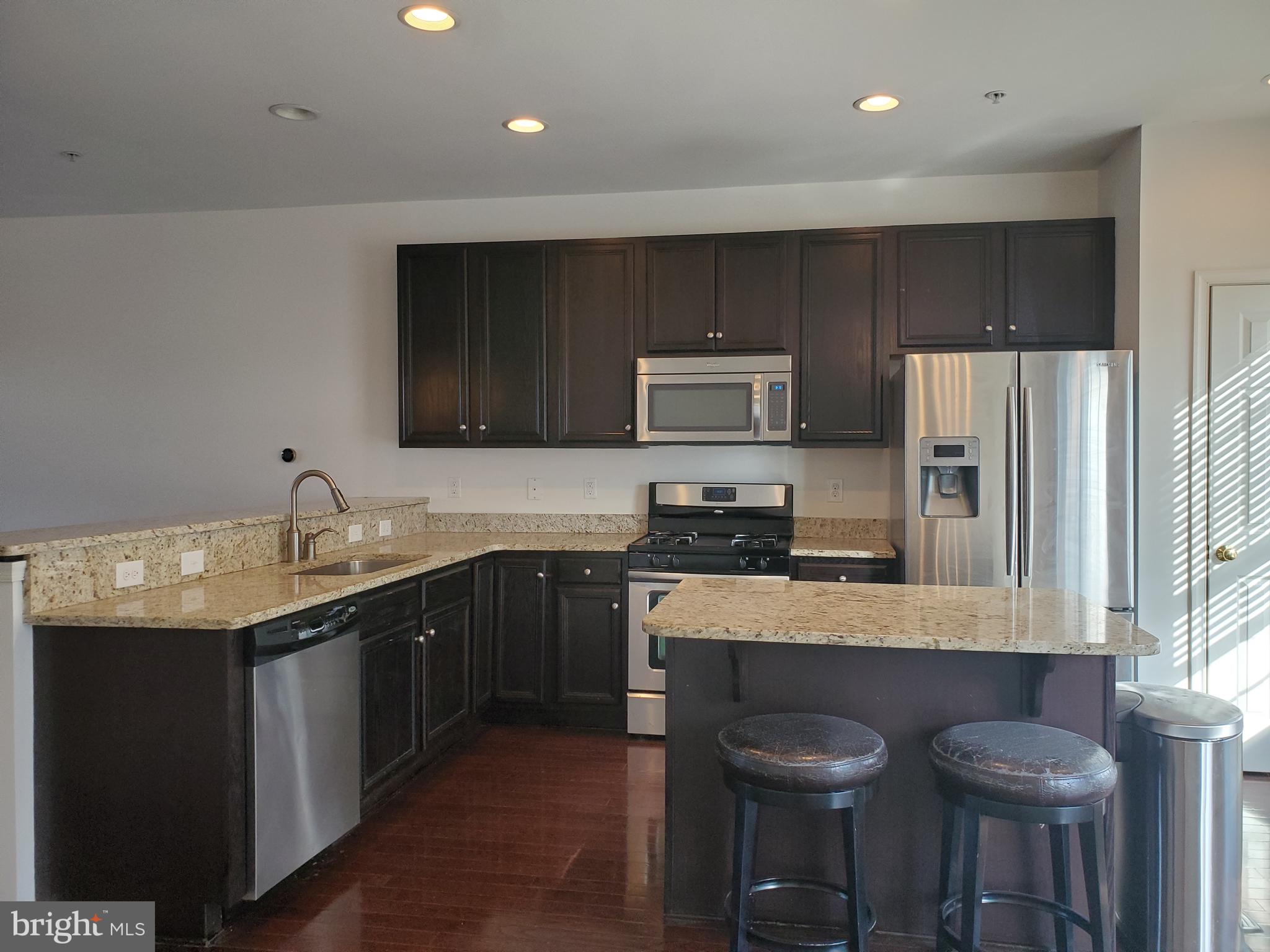 327 Lenape Way Claymont, DE 19703 - Photo 6 of 17 a kitchen with granite countertop a sink stainless steel appliances and cabinets