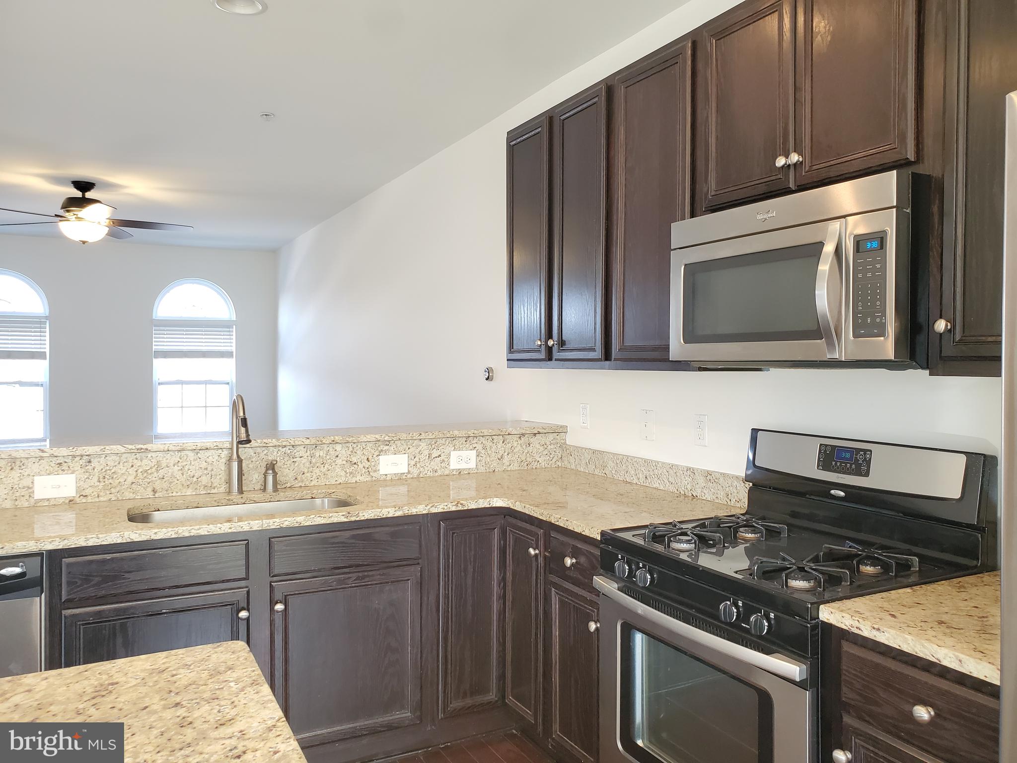 327 Lenape Way Claymont, DE 19703 - Photo 7 of 17 a kitchen with granite countertop a stove and a sink