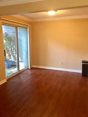 a view of an empty room with a floor to ceiling window