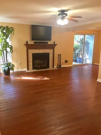 a view of empty room with fireplace and flat screen tv