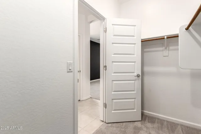an empty room with closet and windows