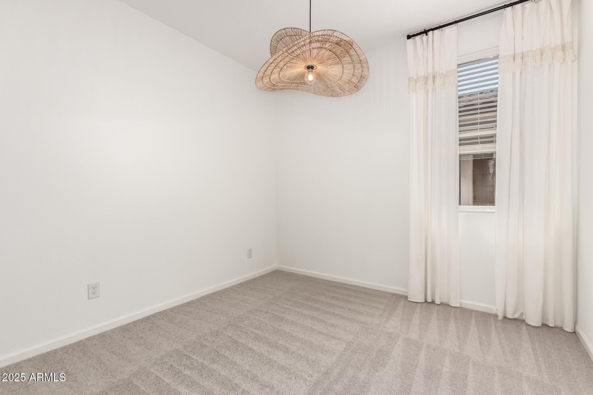 12524 West Trumbull Road Avondale, AZ 85323 - Photo 19 of 34 an empty room with a window