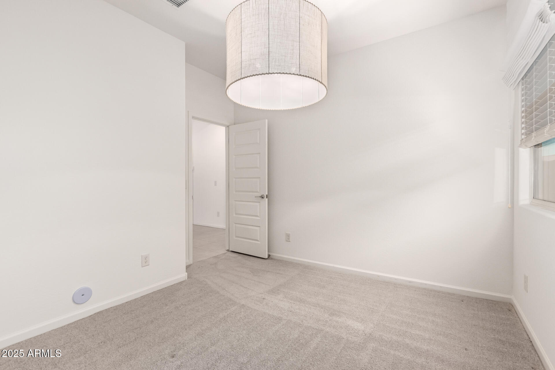 12524 West Trumbull Road Avondale, AZ 85323 - Photo 22 of 34 a view of a room with a sink and a mirror