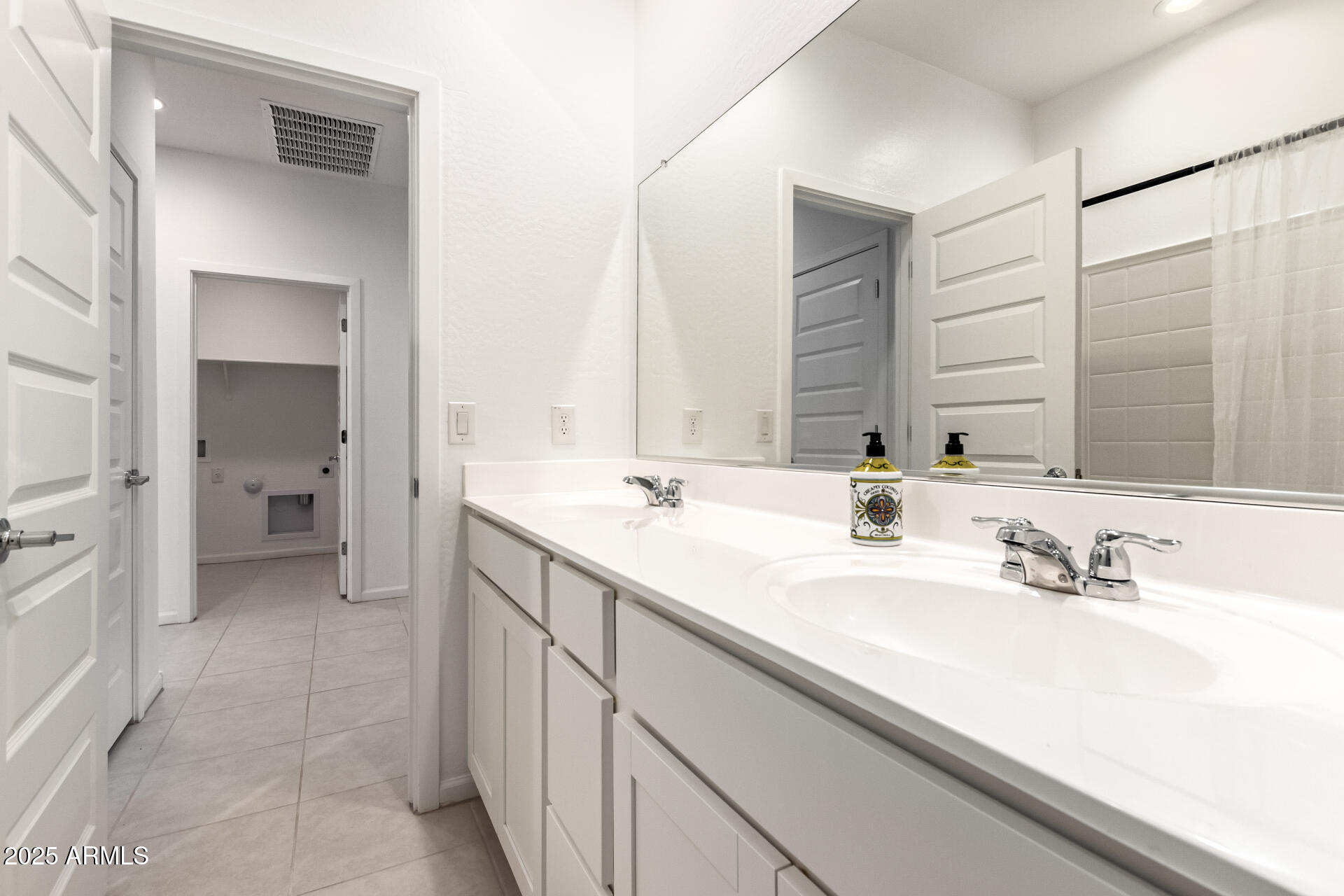 12524 West Trumbull Road Avondale, AZ 85323 - Photo 23 of 34 a bathroom with a sink and a mirror
